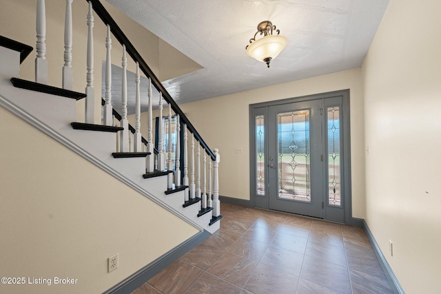 foyer entrance featuring baseboards