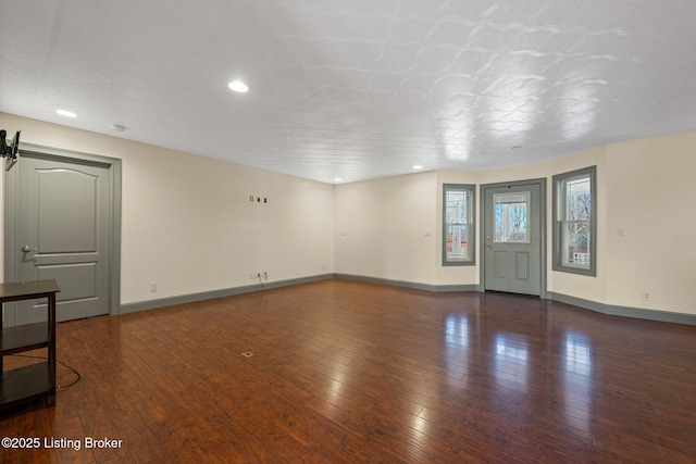 interior space featuring recessed lighting, baseboards, and hardwood / wood-style flooring