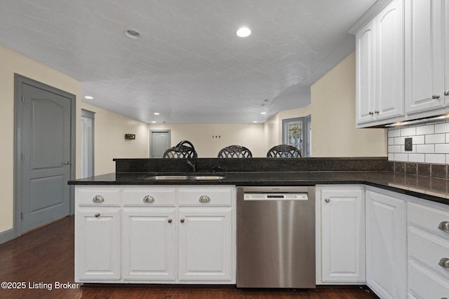 kitchen with dark wood-style floors, backsplash, white cabinetry, a sink, and dishwasher