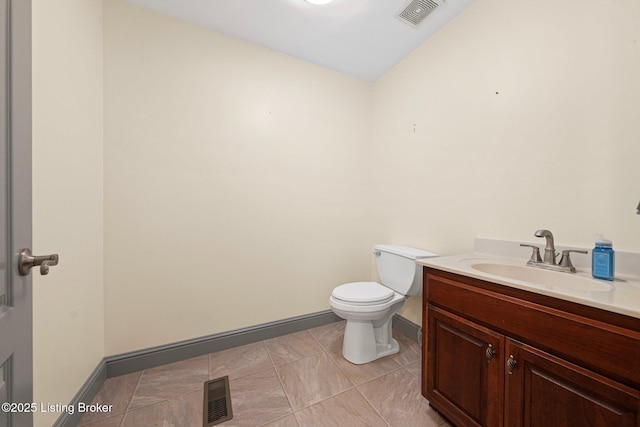 bathroom with toilet, baseboards, visible vents, and vanity