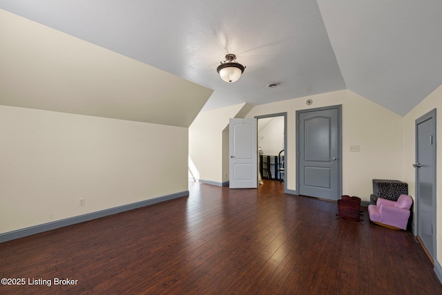 bonus room featuring lofted ceiling, wood-type flooring, and baseboards