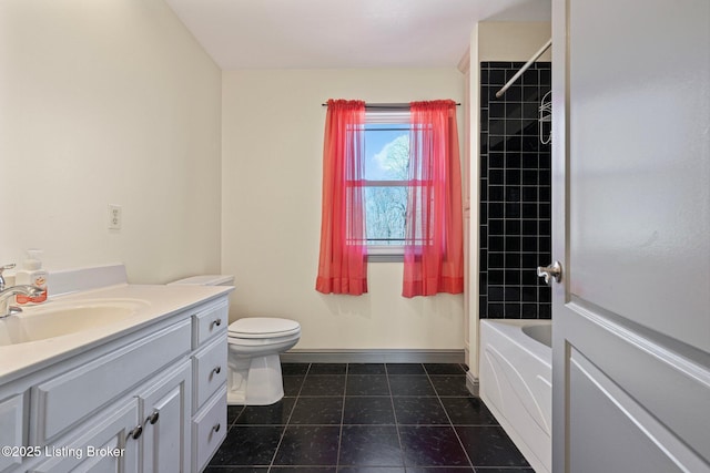 bathroom featuring toilet, shower / bath combination, vanity, baseboards, and tile patterned floors