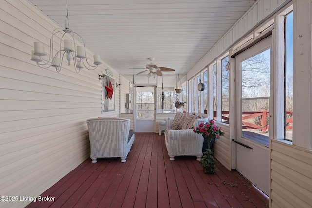 sunroom featuring a ceiling fan