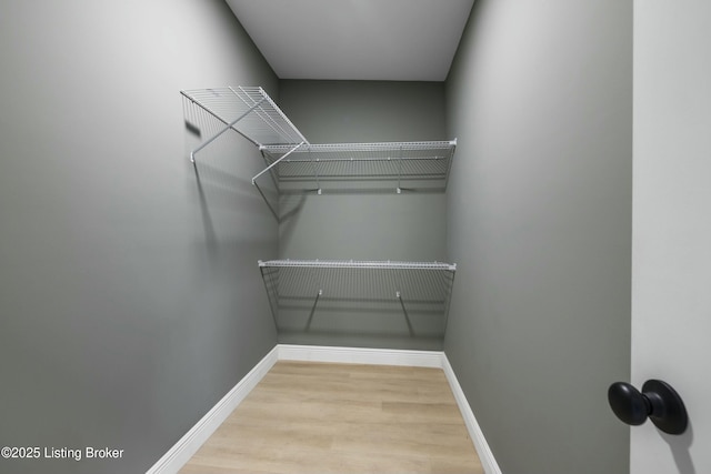 spacious closet with wood finished floors