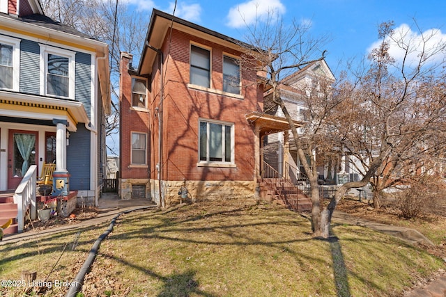 view of property exterior with brick siding and a yard