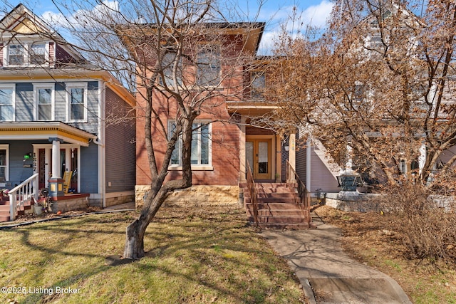 view of front of property with brick siding and a front lawn