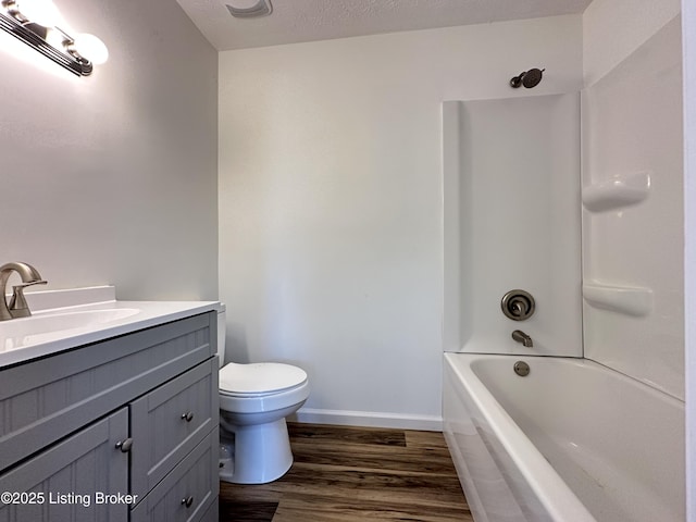 full bath with toilet, baseboards, wood finished floors, and vanity