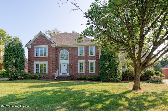 view of front of property with a front yard and brick siding