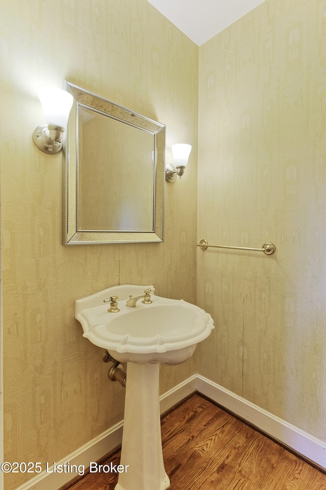 bathroom featuring baseboards and wood finished floors