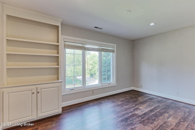 spare room featuring baseboards, visible vents, dark wood-style flooring, and recessed lighting