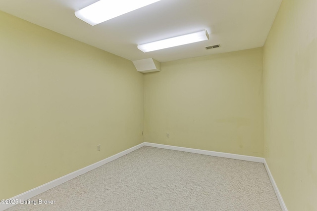 spare room with light carpet, baseboards, and visible vents