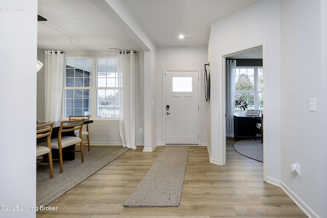 entryway featuring baseboards, recessed lighting, and light wood-style floors