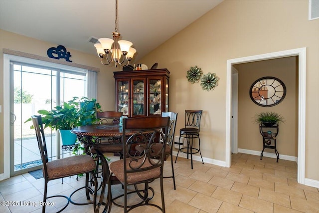 dining space featuring vaulted ceiling, baseboards, visible vents, and an inviting chandelier