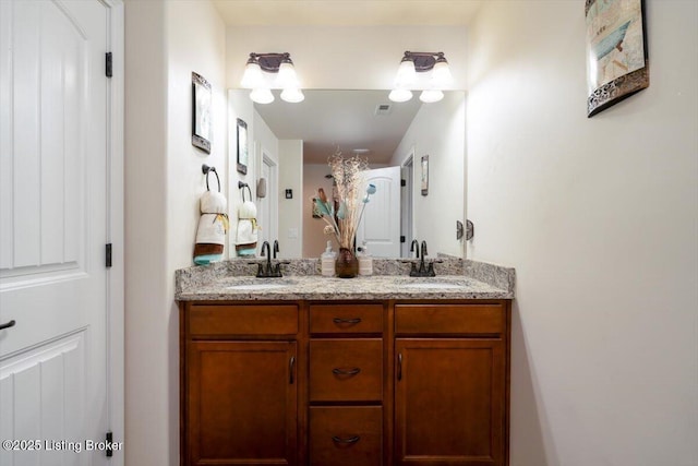 bathroom with double vanity and a sink