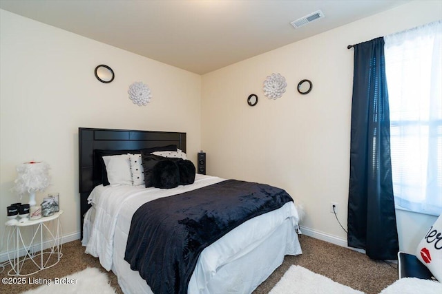 carpeted bedroom with visible vents and baseboards