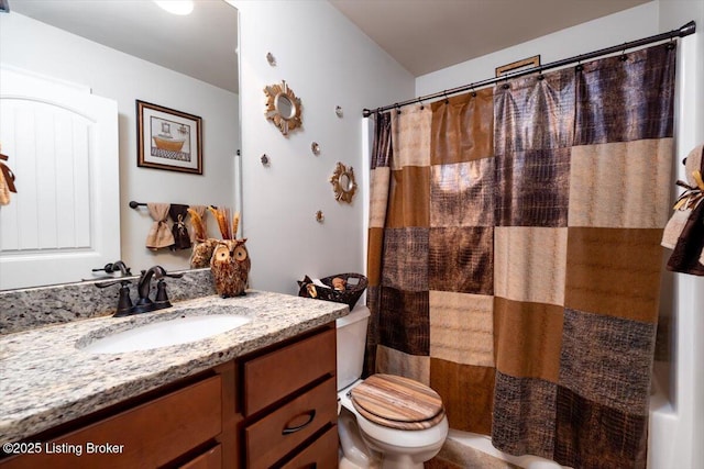 full bathroom featuring curtained shower, vanity, and toilet