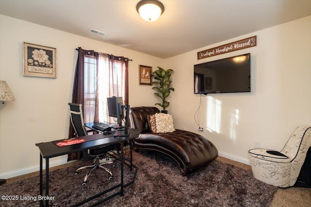 carpeted office space with baseboards and visible vents