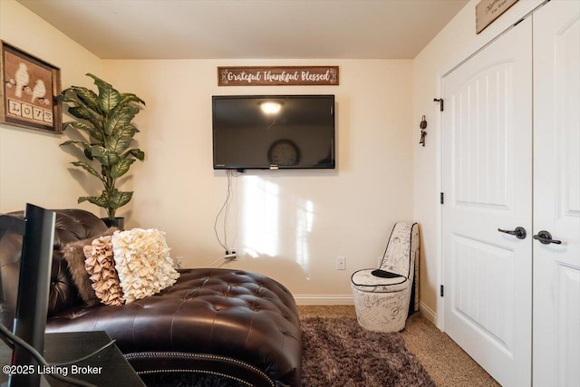 living room featuring baseboards and carpet flooring