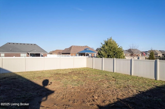 view of yard with fence and a residential view