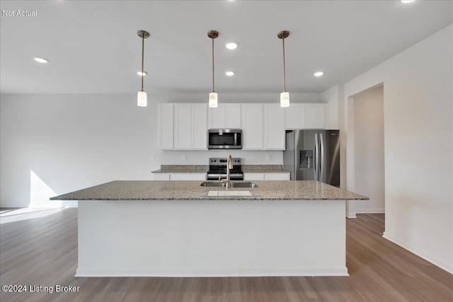 kitchen featuring an island with sink, white cabinets, stainless steel appliances, and a sink