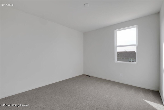 unfurnished room featuring carpet floors and visible vents