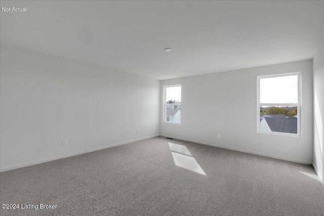 empty room with carpet floors and baseboards