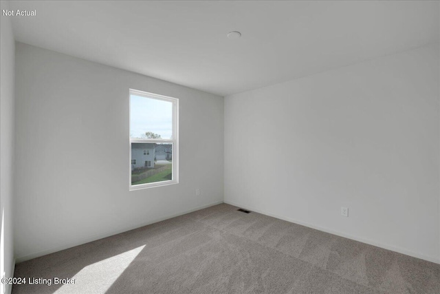 spare room featuring carpet and visible vents