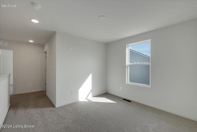 empty room featuring carpet, visible vents, baseboards, and recessed lighting