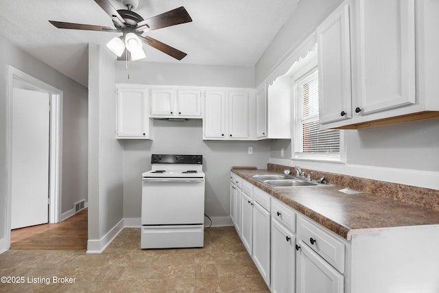 kitchen with white electric range oven, visible vents, white cabinetry, a sink, and baseboards