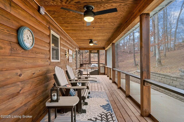 wooden deck with covered porch and ceiling fan