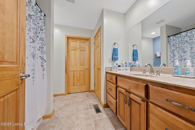 bathroom featuring vanity, visible vents, and tile patterned floors