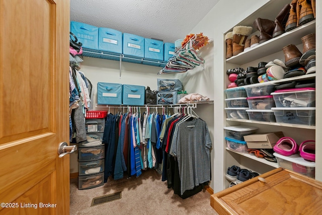 walk in closet with carpet floors and visible vents