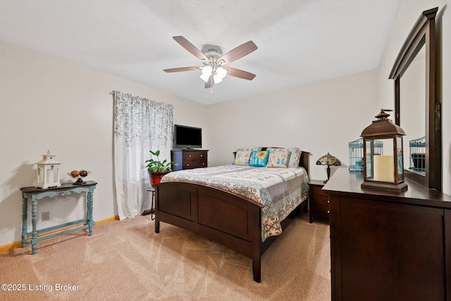 bedroom featuring a textured ceiling, baseboards, a ceiling fan, and light colored carpet