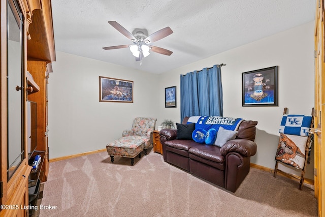 carpeted living room featuring a textured ceiling, a ceiling fan, and baseboards