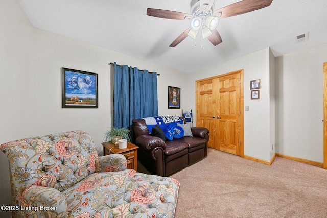 living area featuring a ceiling fan, carpet, visible vents, and baseboards