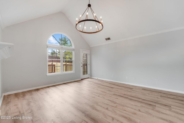 unfurnished room featuring baseboards, high vaulted ceiling, a chandelier, and wood finished floors