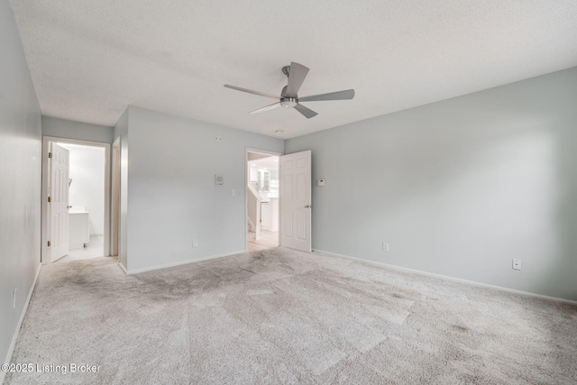 unfurnished bedroom featuring a ceiling fan, carpet flooring, a textured ceiling, and baseboards