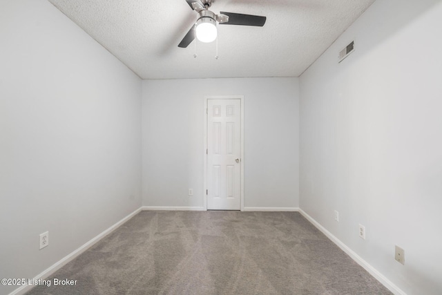 unfurnished room with a textured ceiling, visible vents, baseboards, a ceiling fan, and carpet