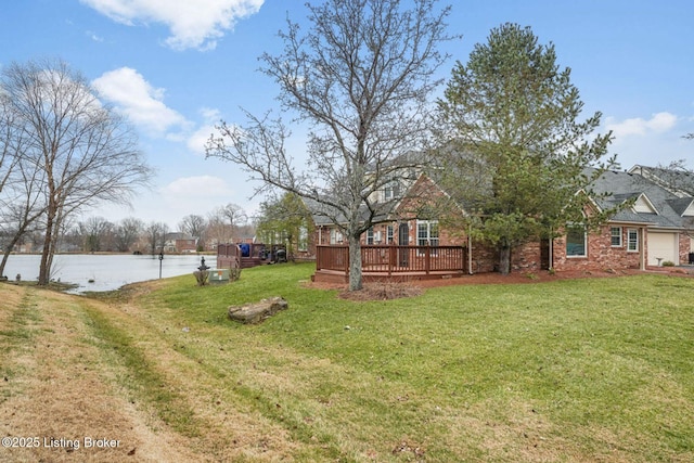 view of yard with a deck with water view