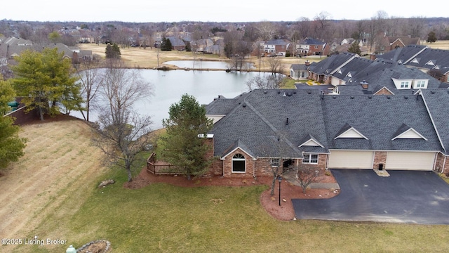 bird's eye view with a residential view and a water view