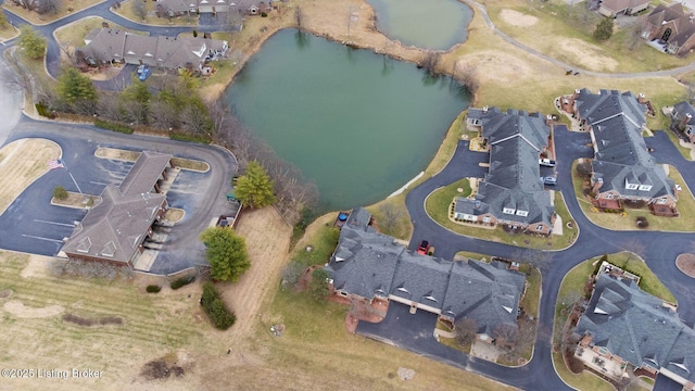 bird's eye view featuring a water view and a residential view