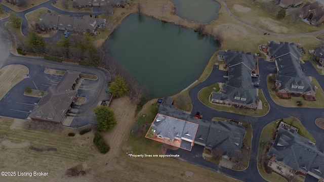 birds eye view of property with a residential view and a water view