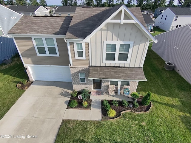 view of front of home with driveway, central AC, a front lawn, and board and batten siding