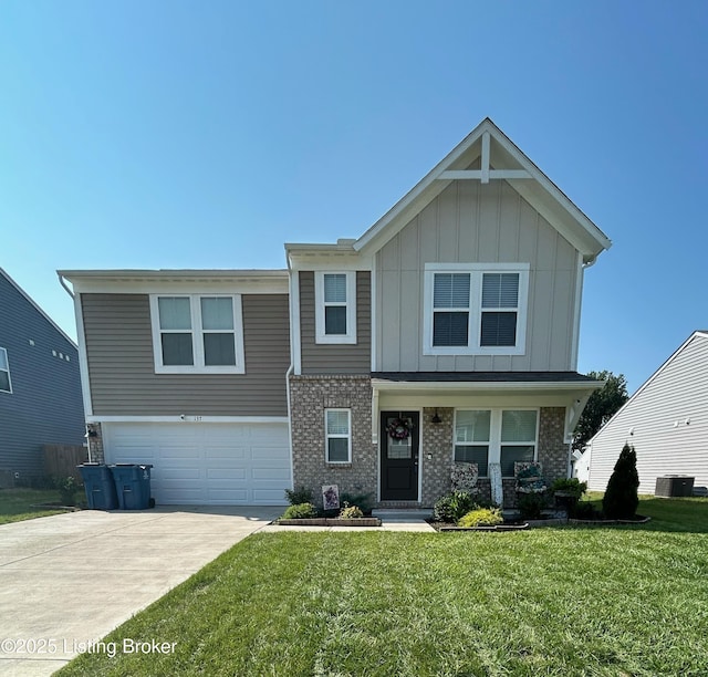 view of front of house with driveway, a garage, a front lawn, board and batten siding, and brick siding