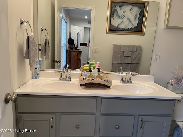 full bathroom featuring a sink and double vanity