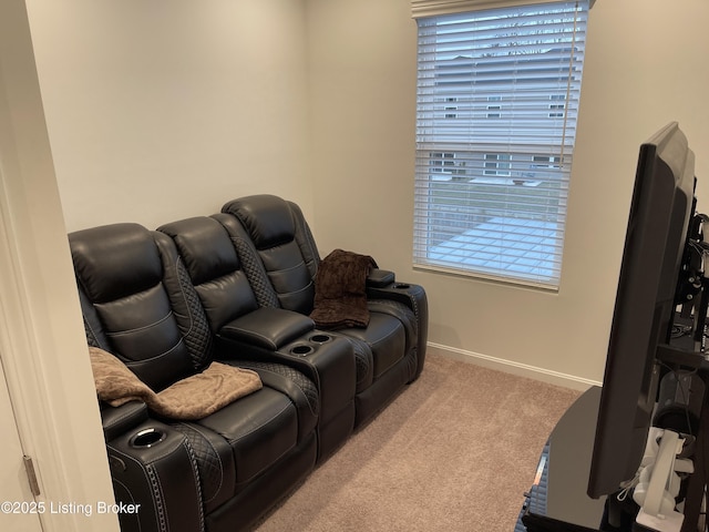 carpeted cinema room with baseboards