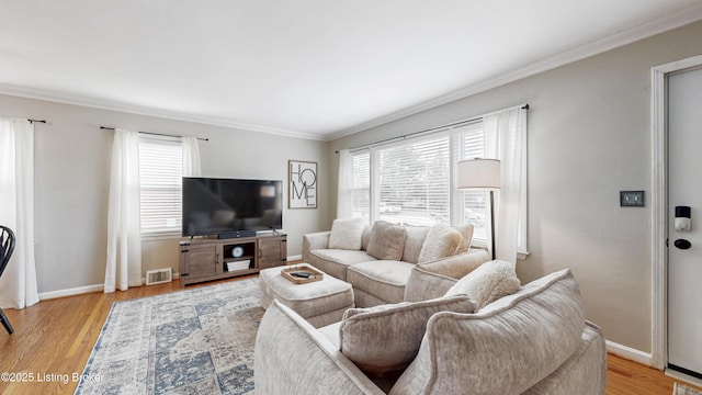 living room featuring light wood-style flooring, visible vents, and baseboards