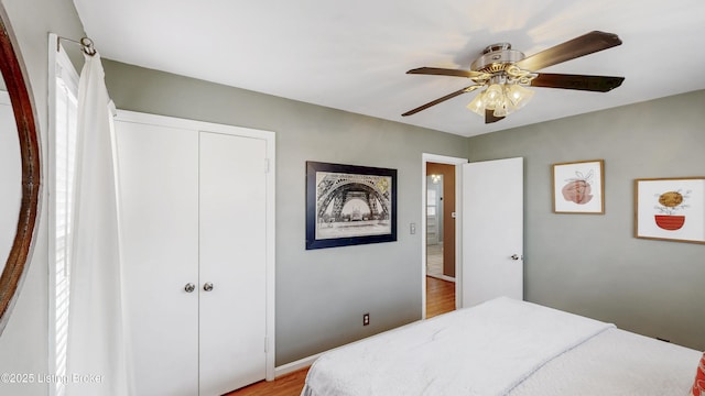 bedroom featuring light wood-style flooring, a closet, and a ceiling fan