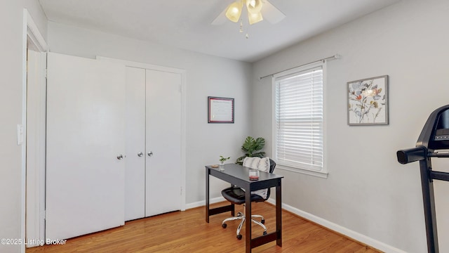 office space with light wood finished floors, baseboards, and a ceiling fan