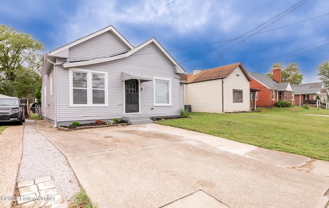 view of front of house with concrete driveway and a front yard